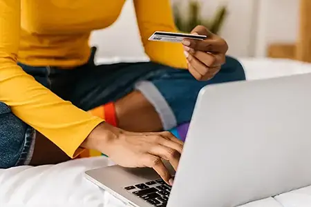 woman on laptop with credit card